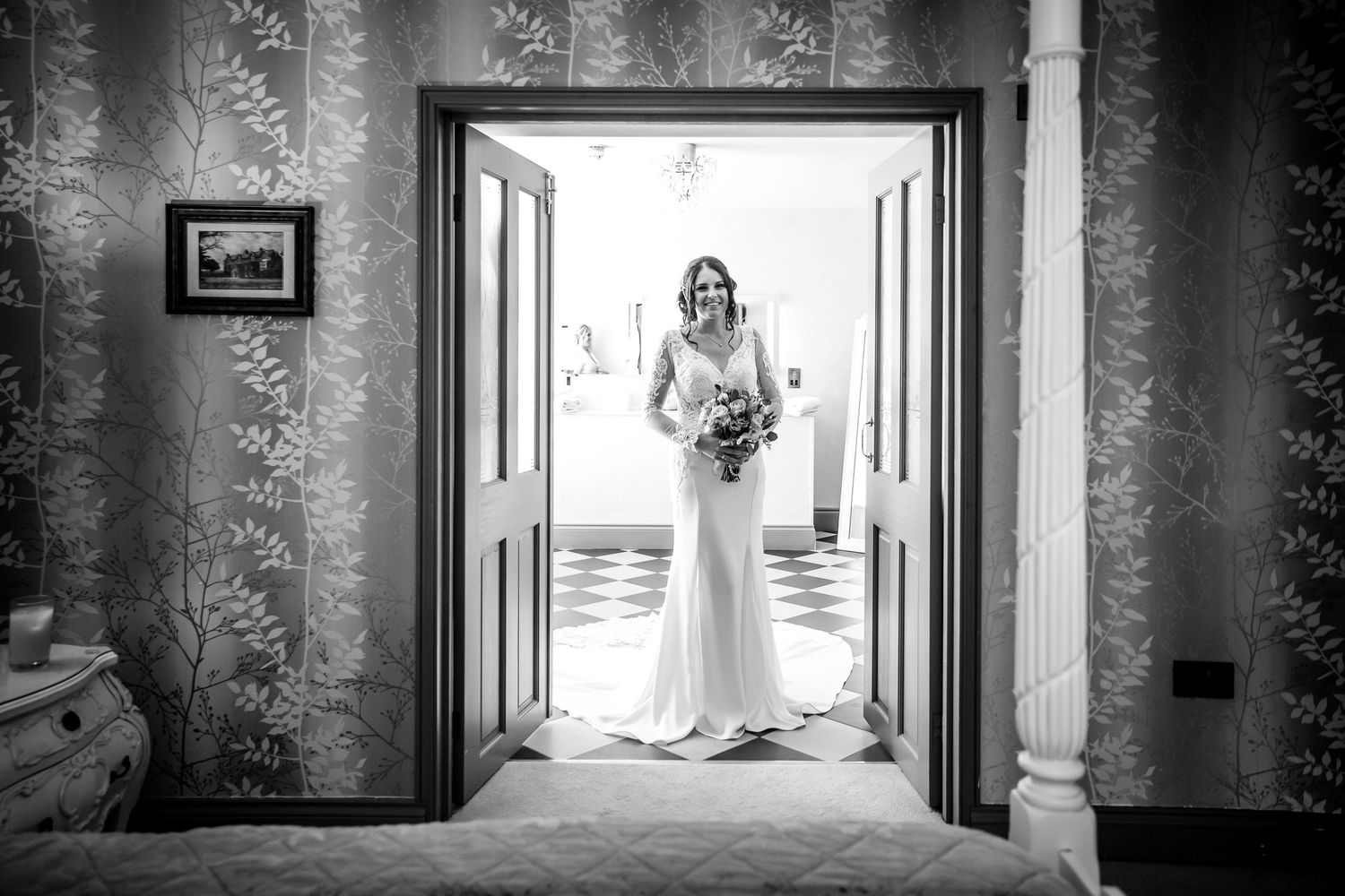 A bride in her wedding dress enters the bridal suits at Southdowns Manor wedding venue near Petersfield