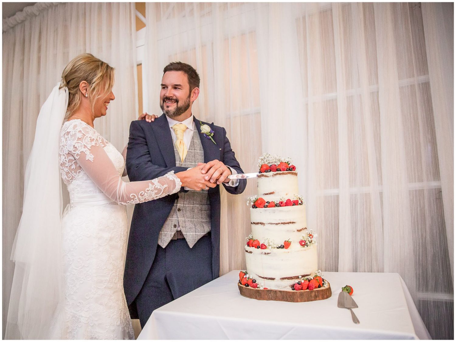 A series of wedding photos showing a couple dancing and celebrating with their strawberry-decorated wedding cake.