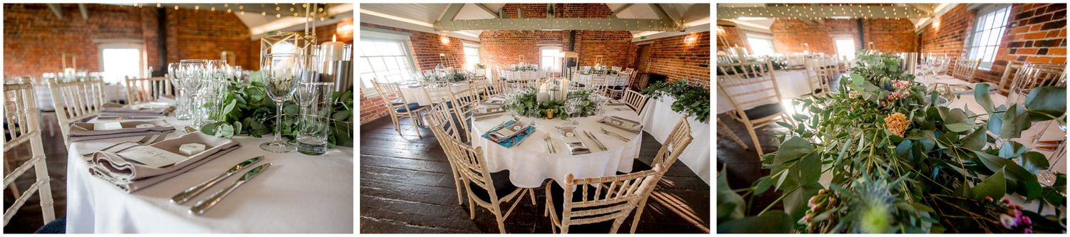 Rustic wedding reception venue with wooden tables, warm lighting and natural decor.