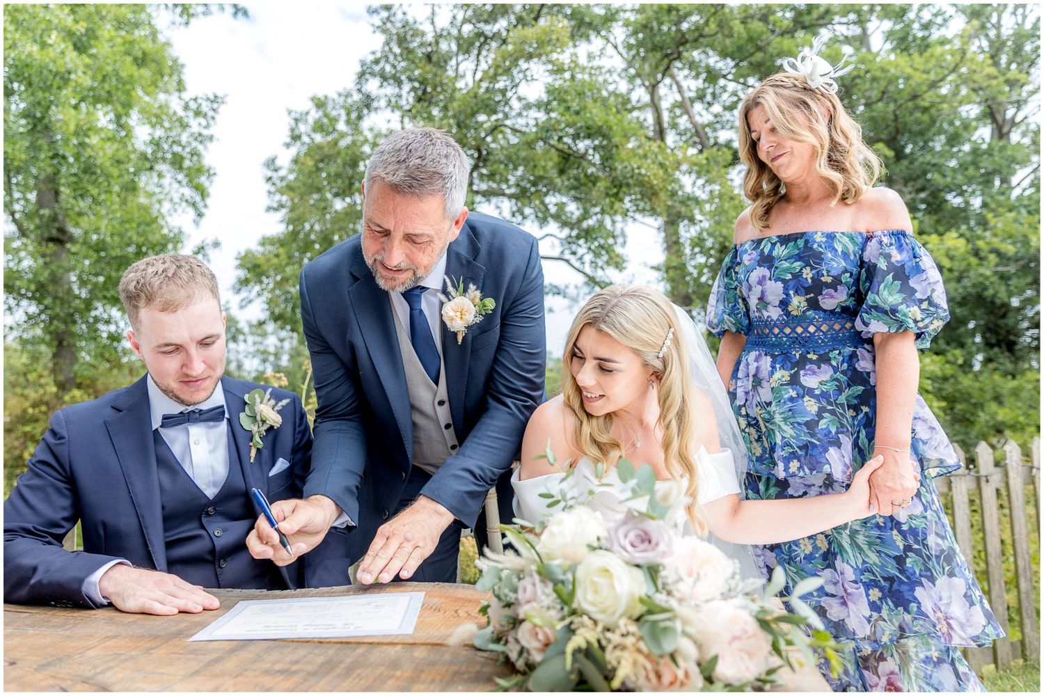 Series of candid moments during wedding ceremony signing and celebrations in outdoor venue.