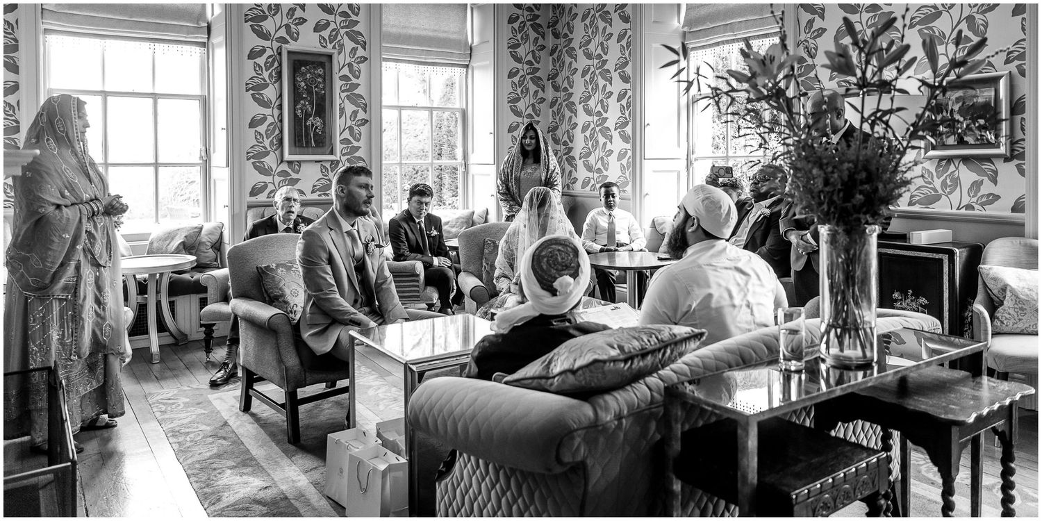 Black and white wedding photos showing tender moments in a vintage-style interior setting.