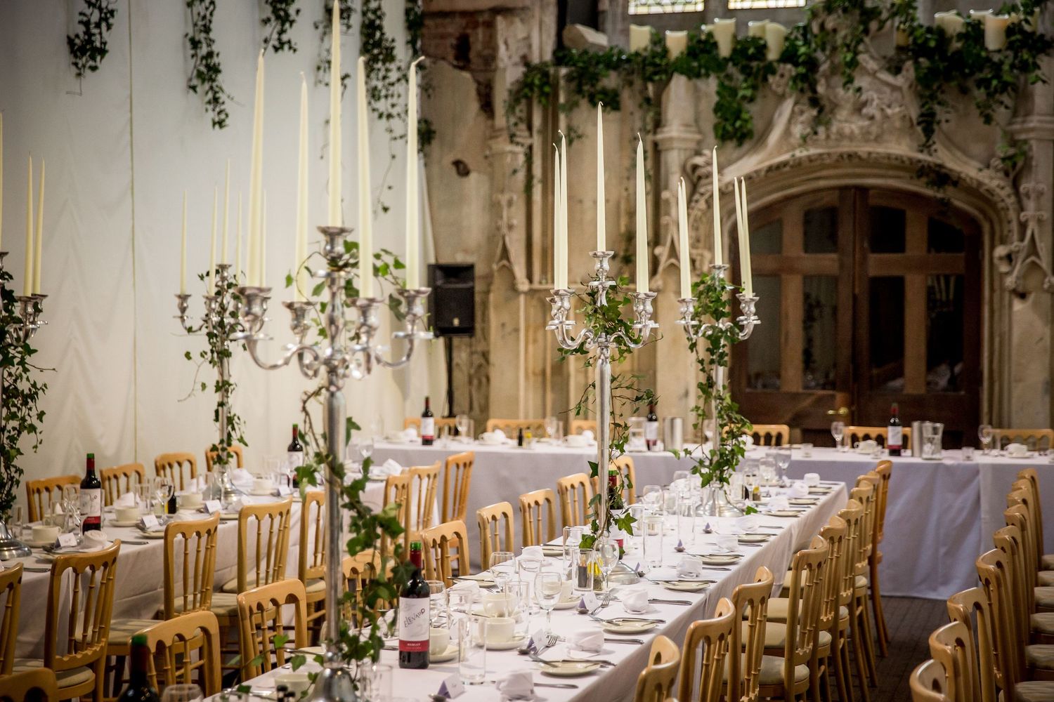 The main dining hall at Highcliffe Castle, with banqueting tables and candles set up for a wedding breakfast