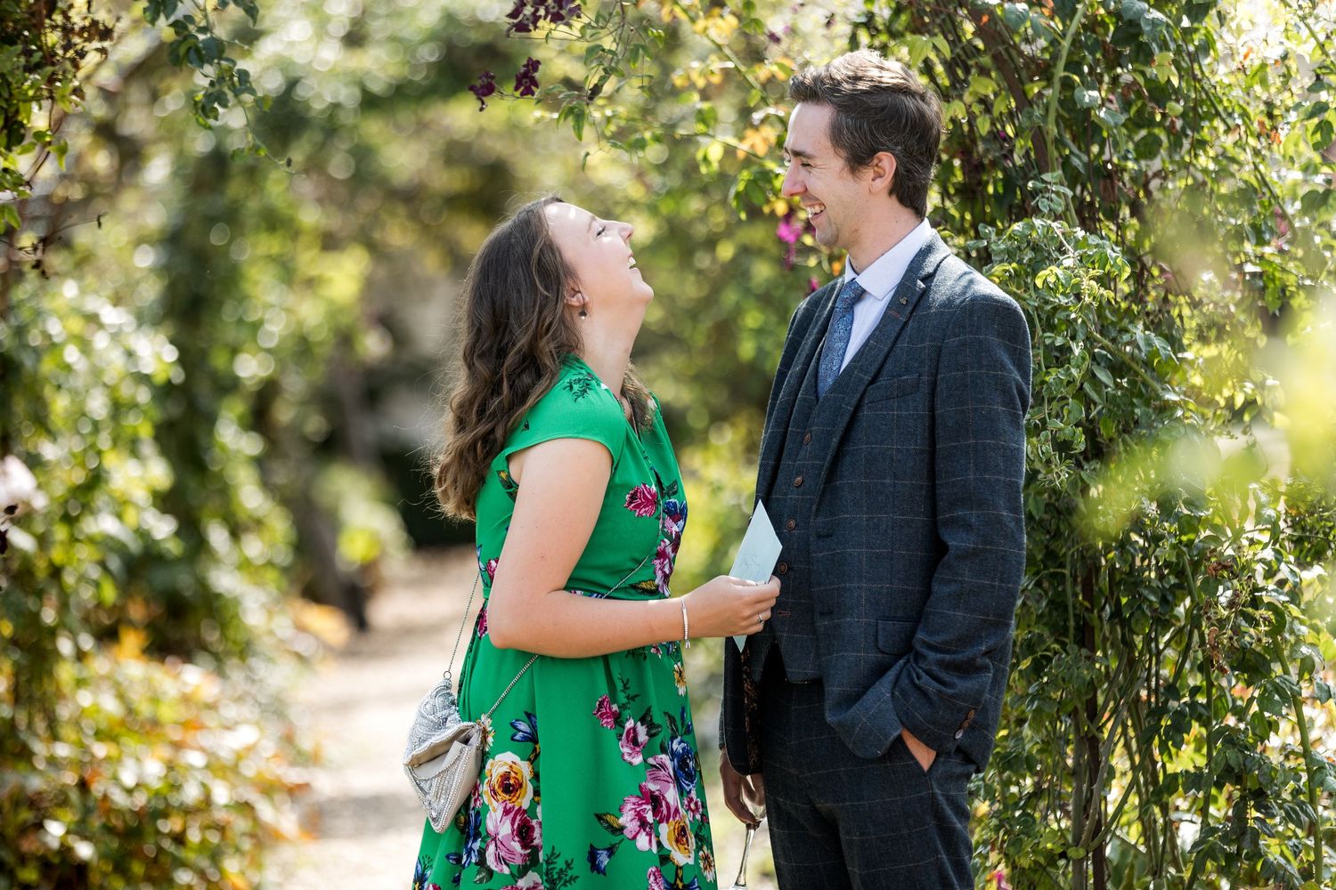 Candid wedding photography of guests exploring the gardens of Houghton Lodge in Hampshire