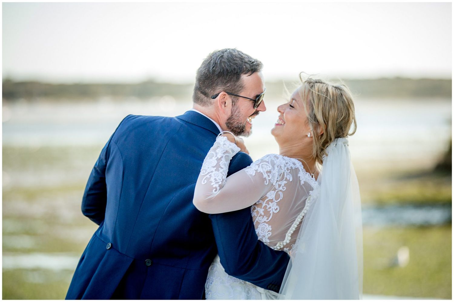 A romantic wedding photo sequence showing tender moments between a couple in formal attire by the water.