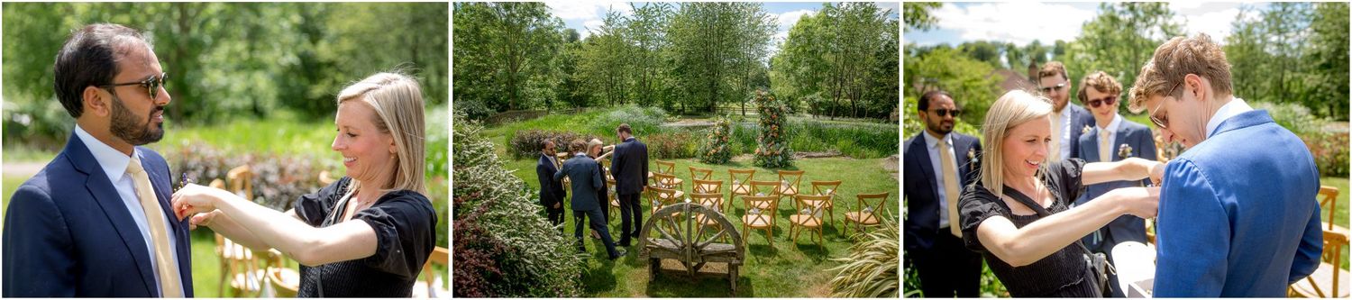 Wedding guests mingling outdoors in lush garden setting.