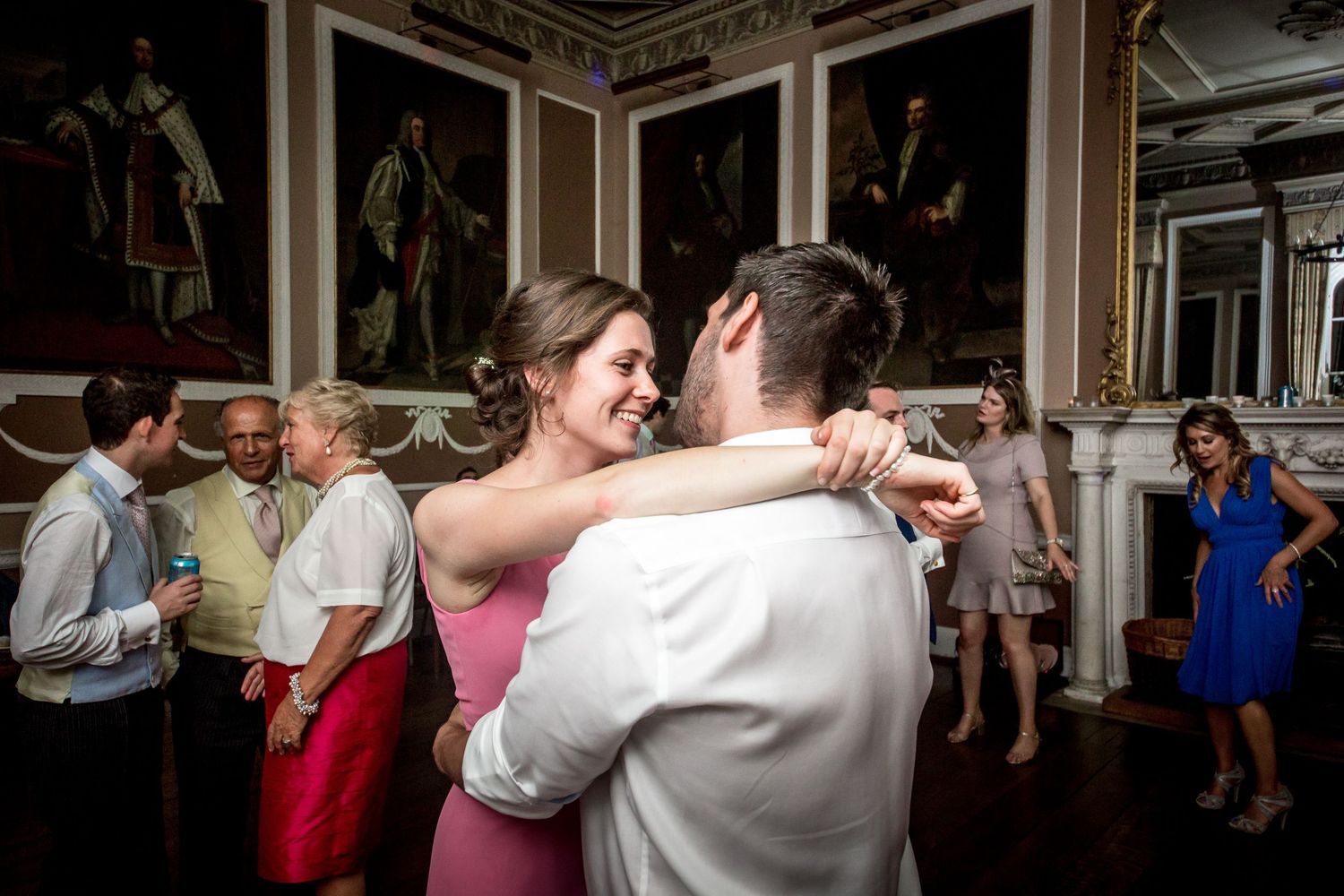 Couples dancing together during a wedding reception in an elegant indoor venue.