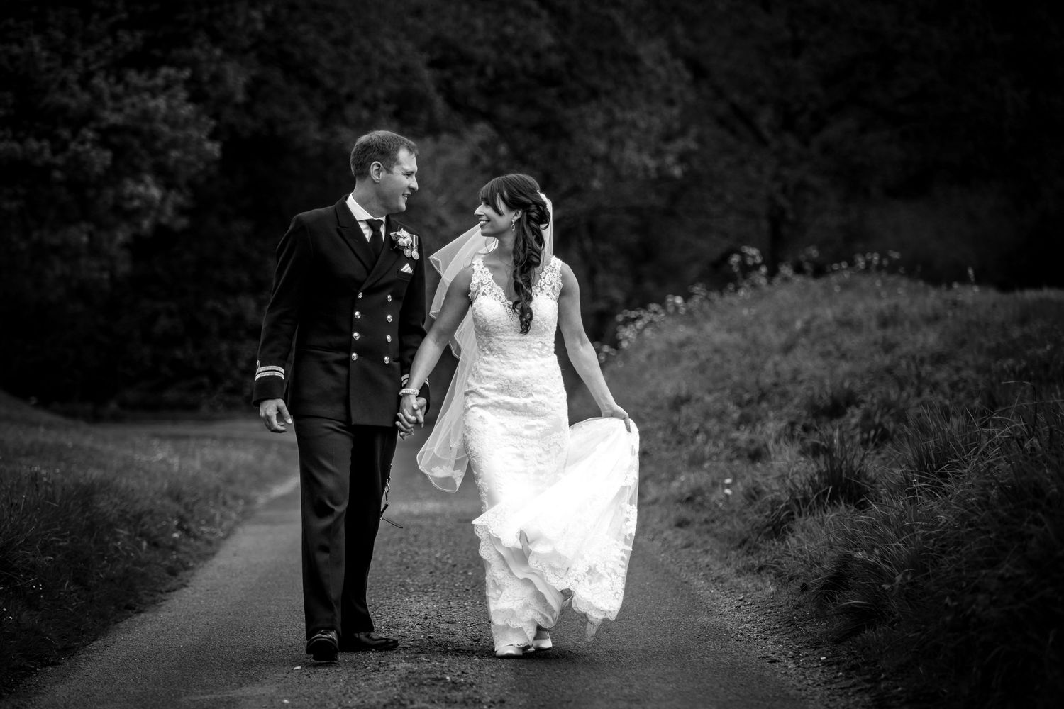 Black and white wedding photography captured in a natural outdoor setting.