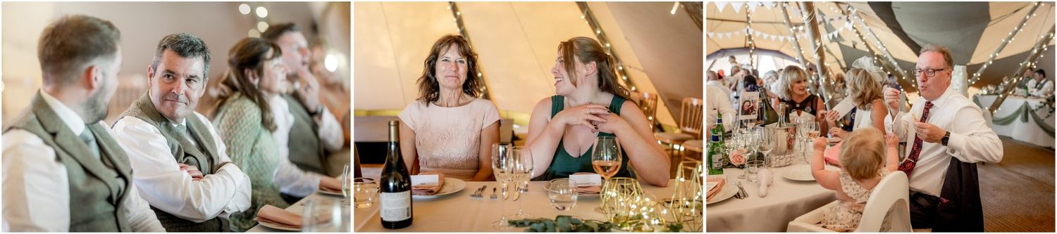 Wedding reception guests enjoying dinner and conversation inside rustic tipi tent.
