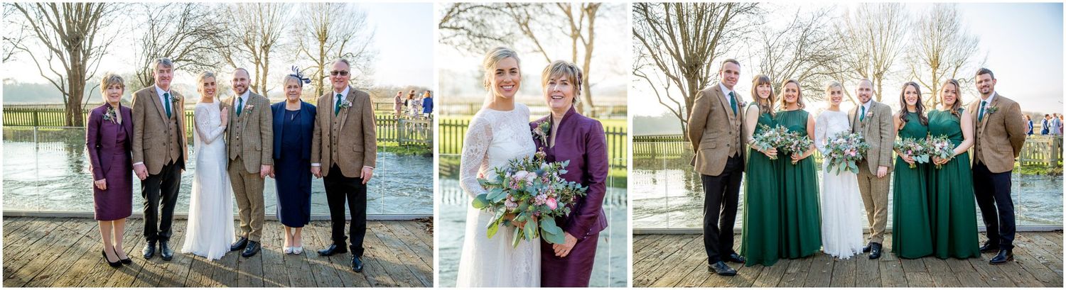 Wedding party poses outdoors on a winter day with bare trees in the background.