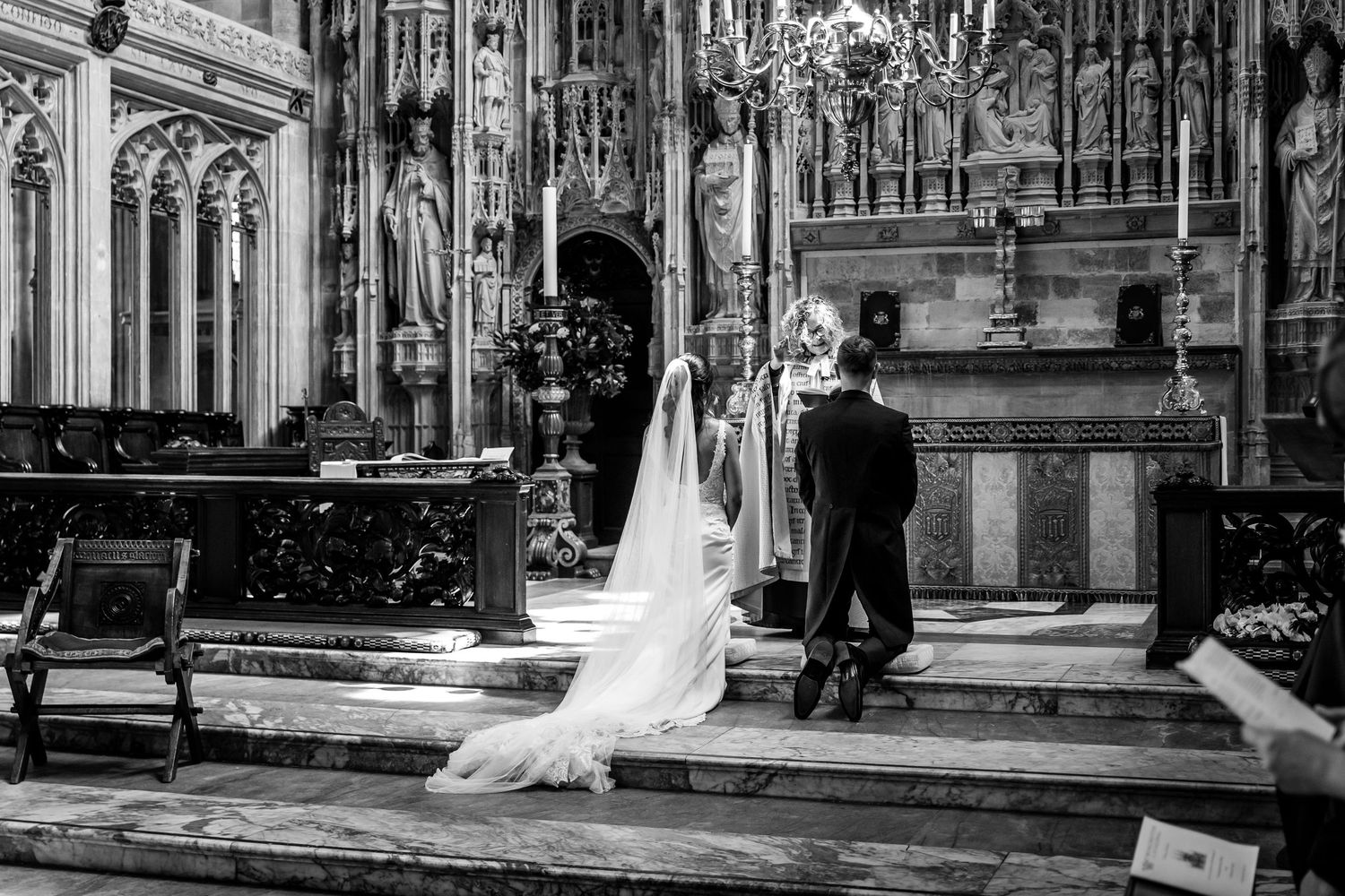 Wide angle view of cathedral wedding ceremony showing architectural details.