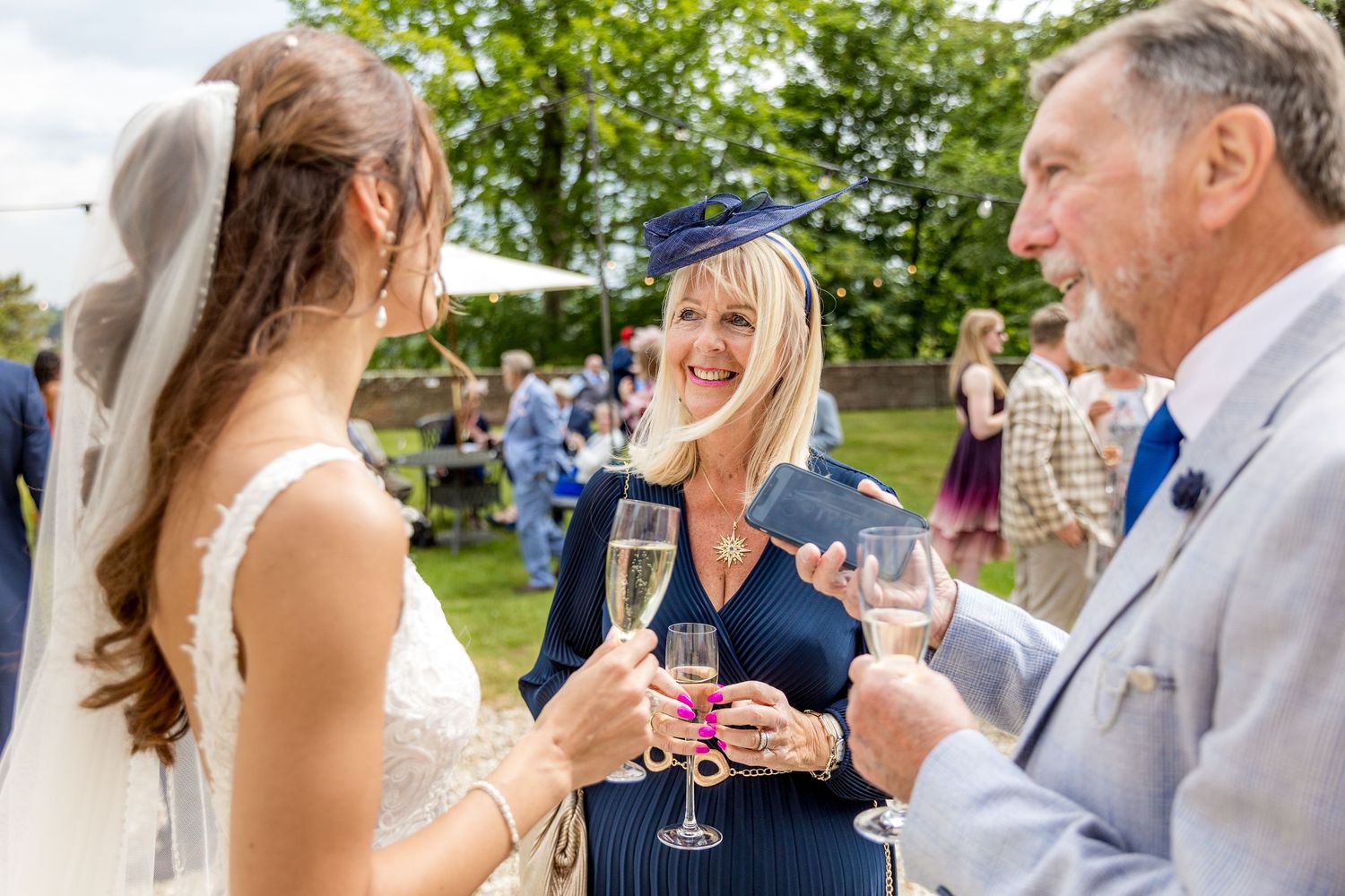Wedding guests mingle during an outdoor summer reception.