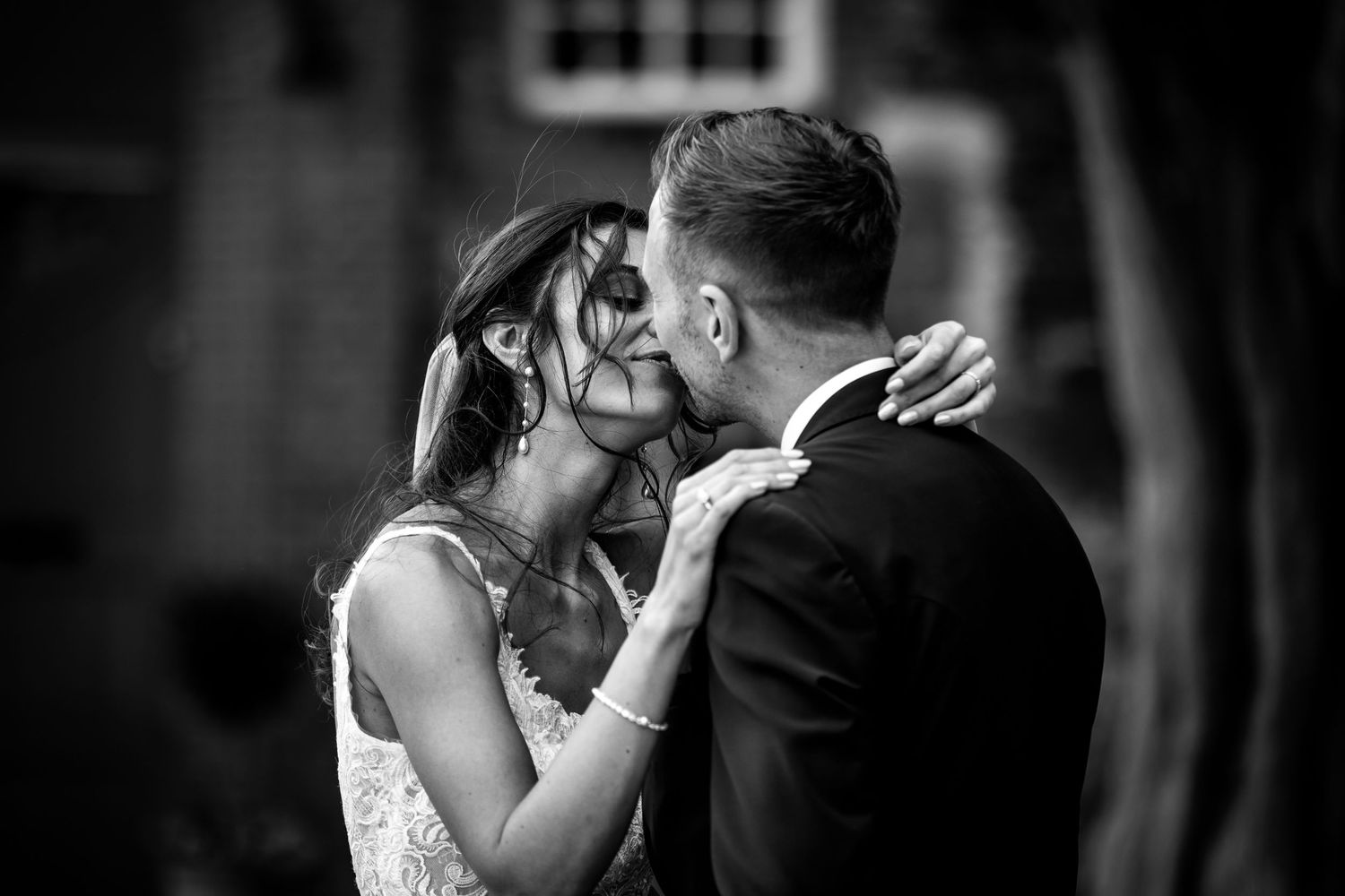 Romantic black and white wedding portraits capturing intimate moments between couple.