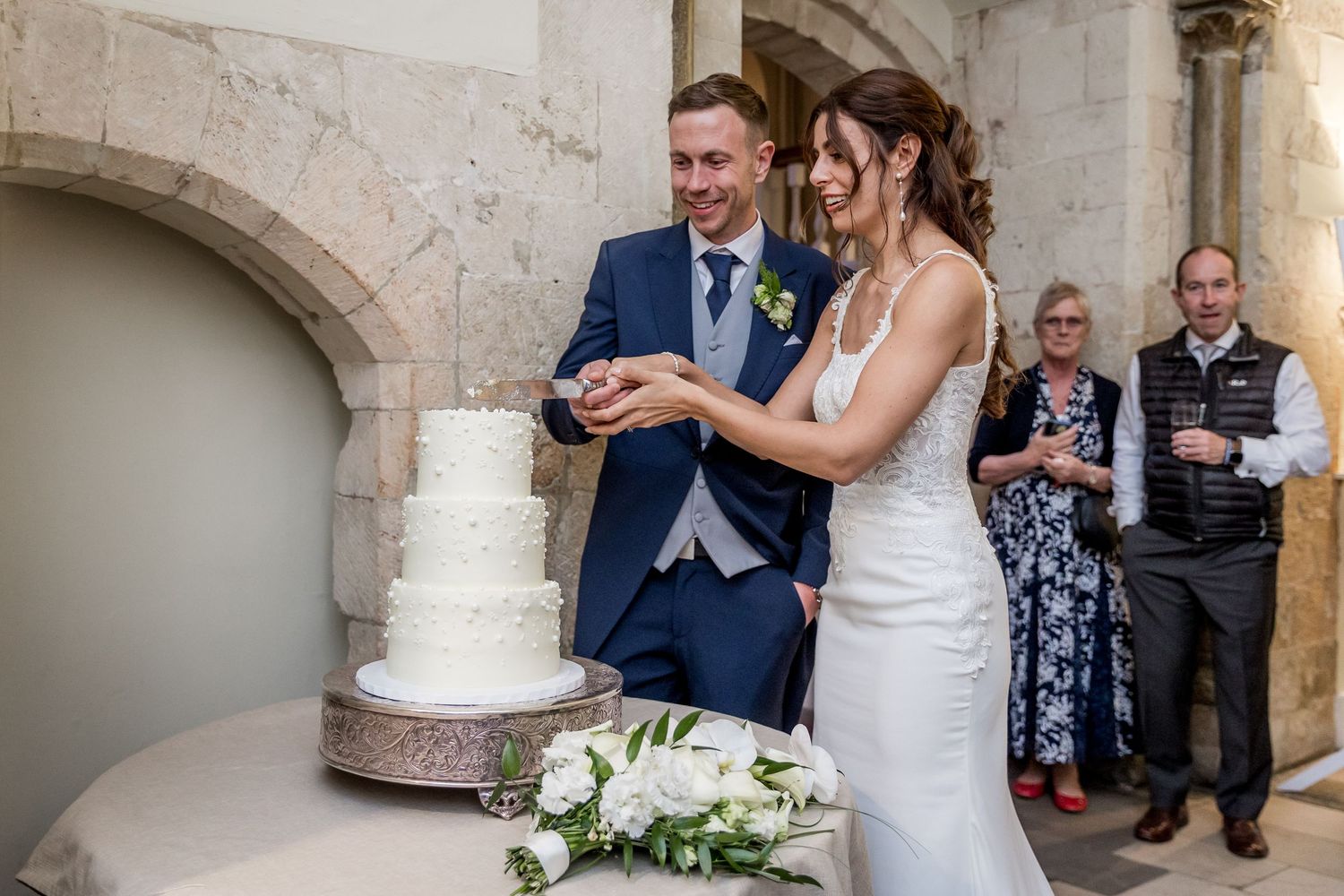 Wedding celebration moments captured at an elegant venue with stone architectural details.
