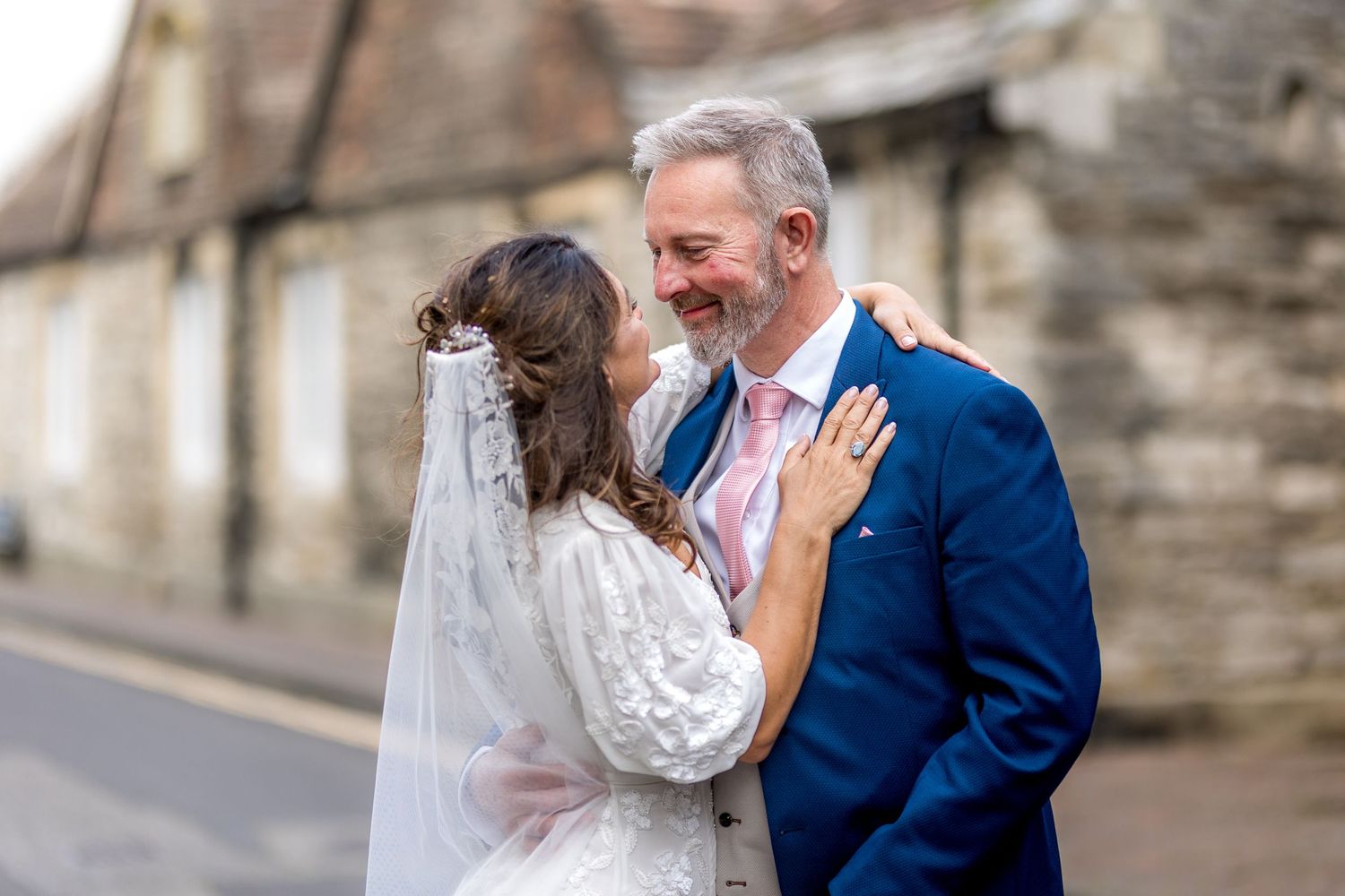 A joyful wedding moment captured on a traditional British town street.