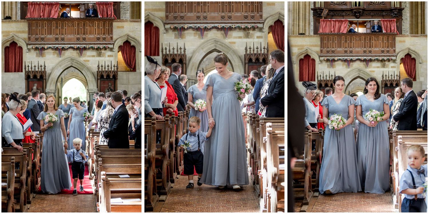 Wedding ceremony in progress inside historic stone church with guests seated.