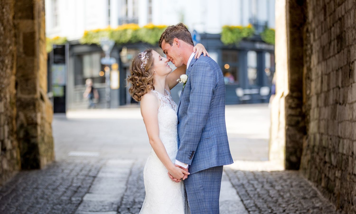 Romantic wedding portraits taken in stone archways and cobblestone streets.