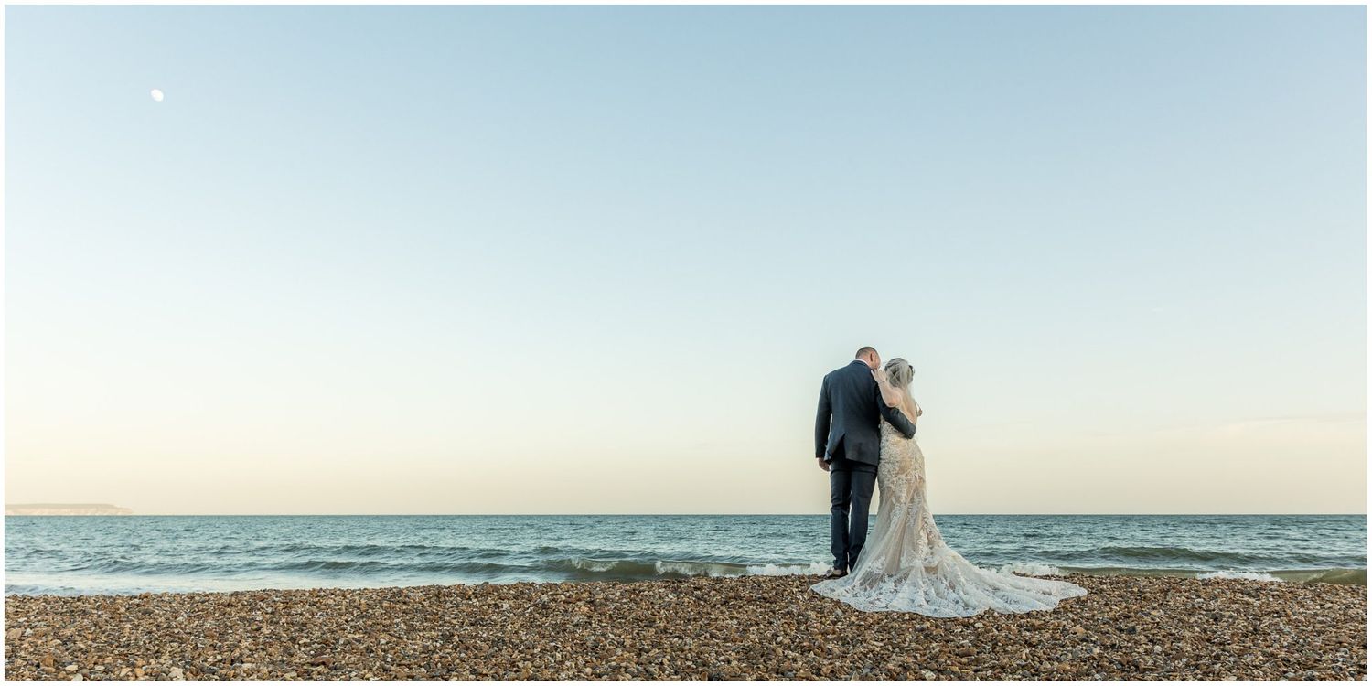 Panoramic beach wedding photos with the ocean and horizon creating a serene backdrop.