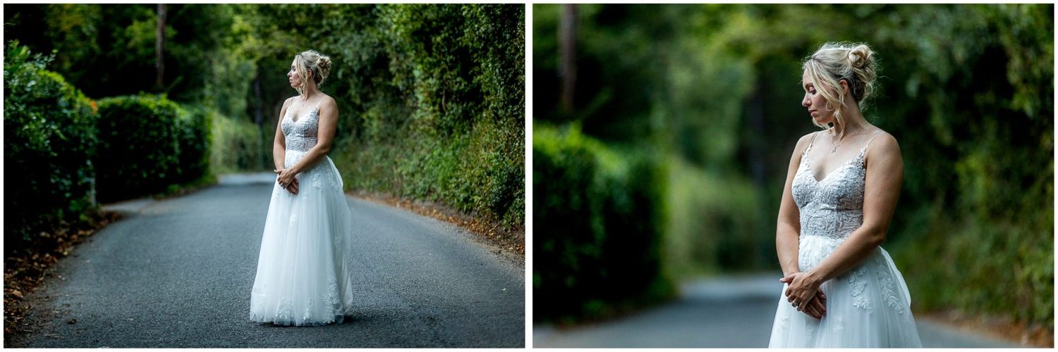 Couple shares romantic moments along tree-lined pathway during wedding photoshoot.