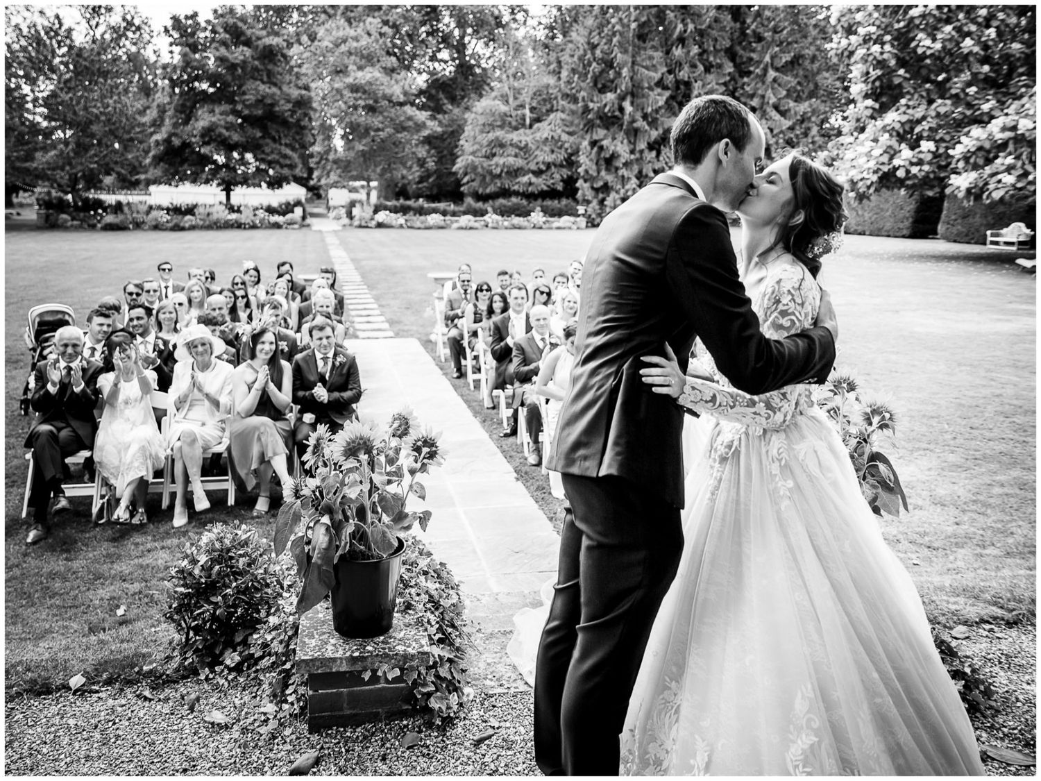A romantic wedding couple shares intimate moments during an outdoor garden ceremony and reception celebration.