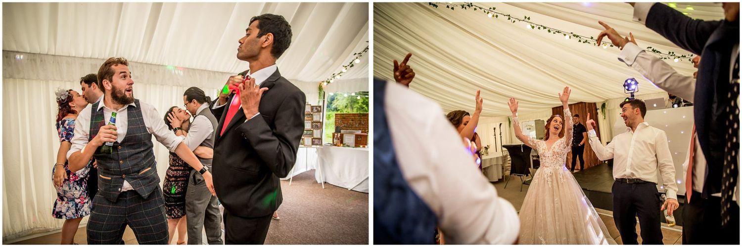 People dancing and celebrating together at a lively wedding reception under an elegant white tent.