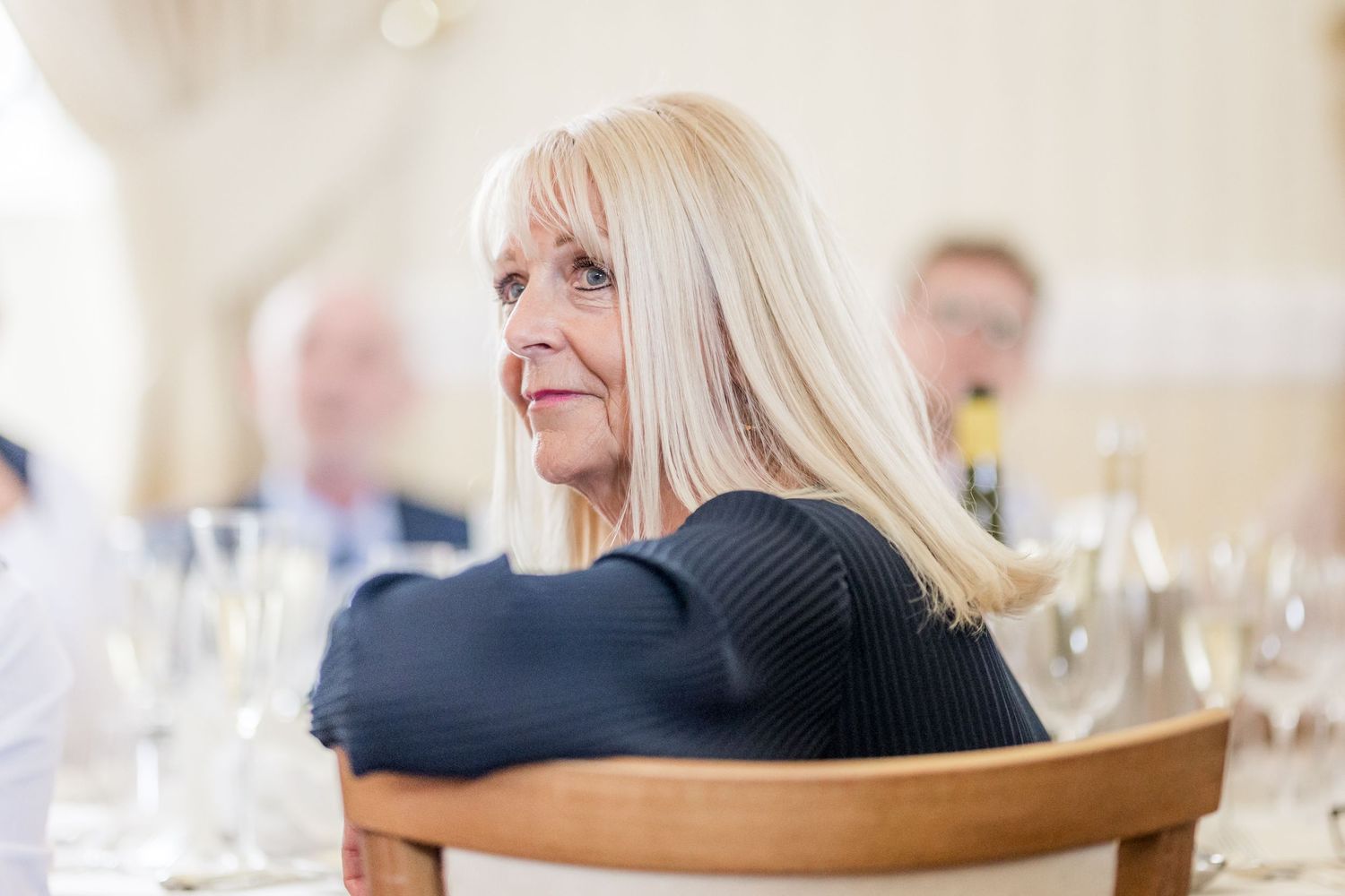 Wedding guests listening intently during reception speeches and toasts.