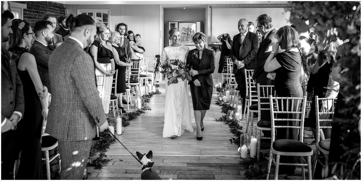 Wedding ceremony moments captured in elegant venue with exposed brick walls.