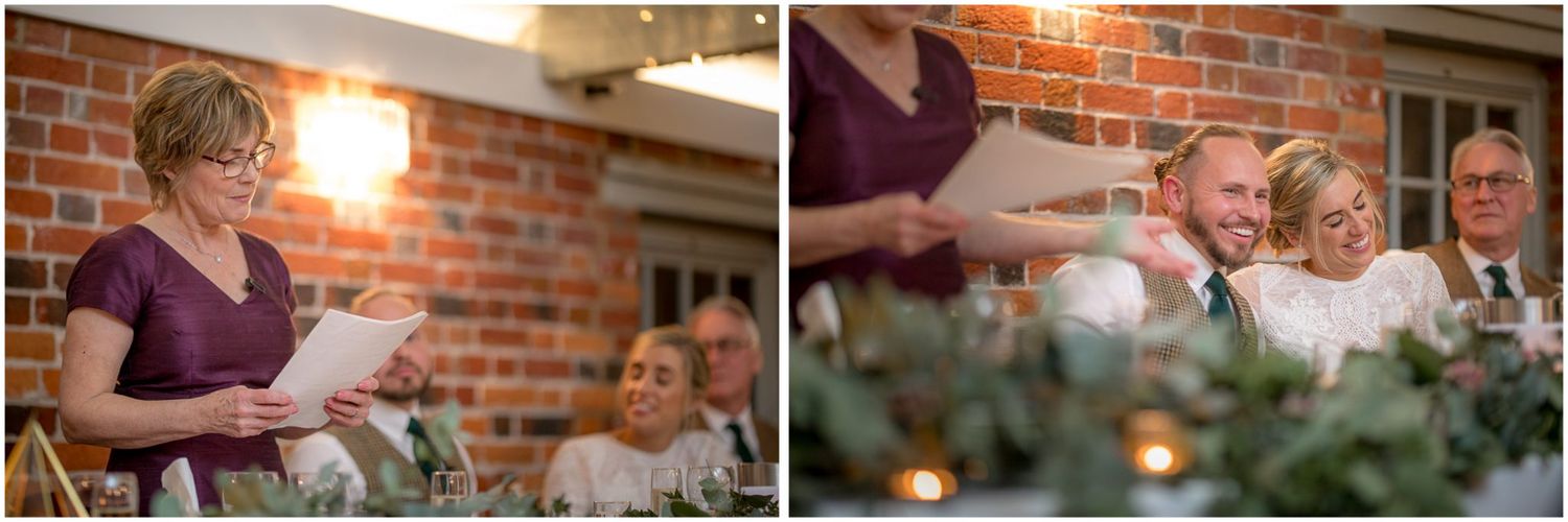 Wedding party celebrating in a rustic brick-walled venue with warm lighting.