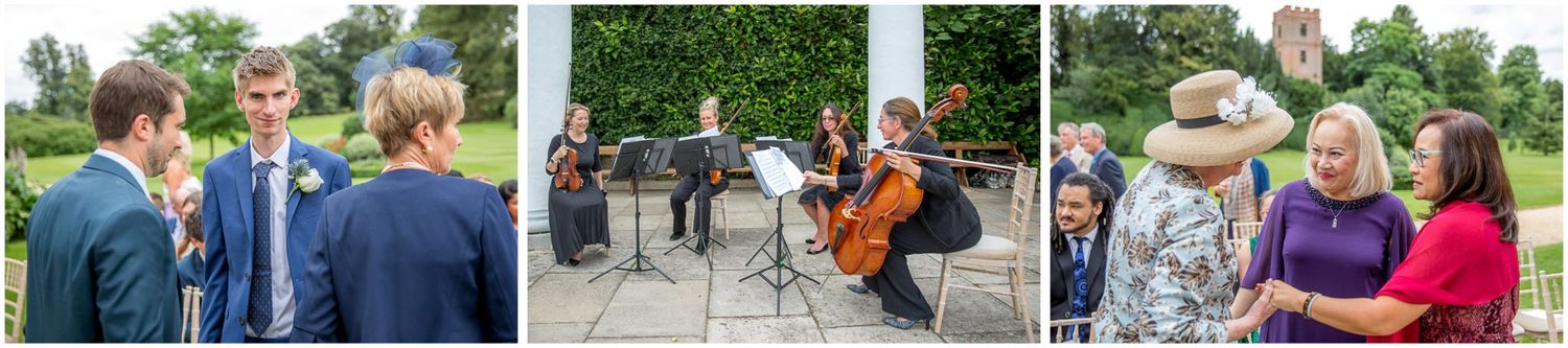 Wedding guests mingle on outdoor patio during summer celebration.