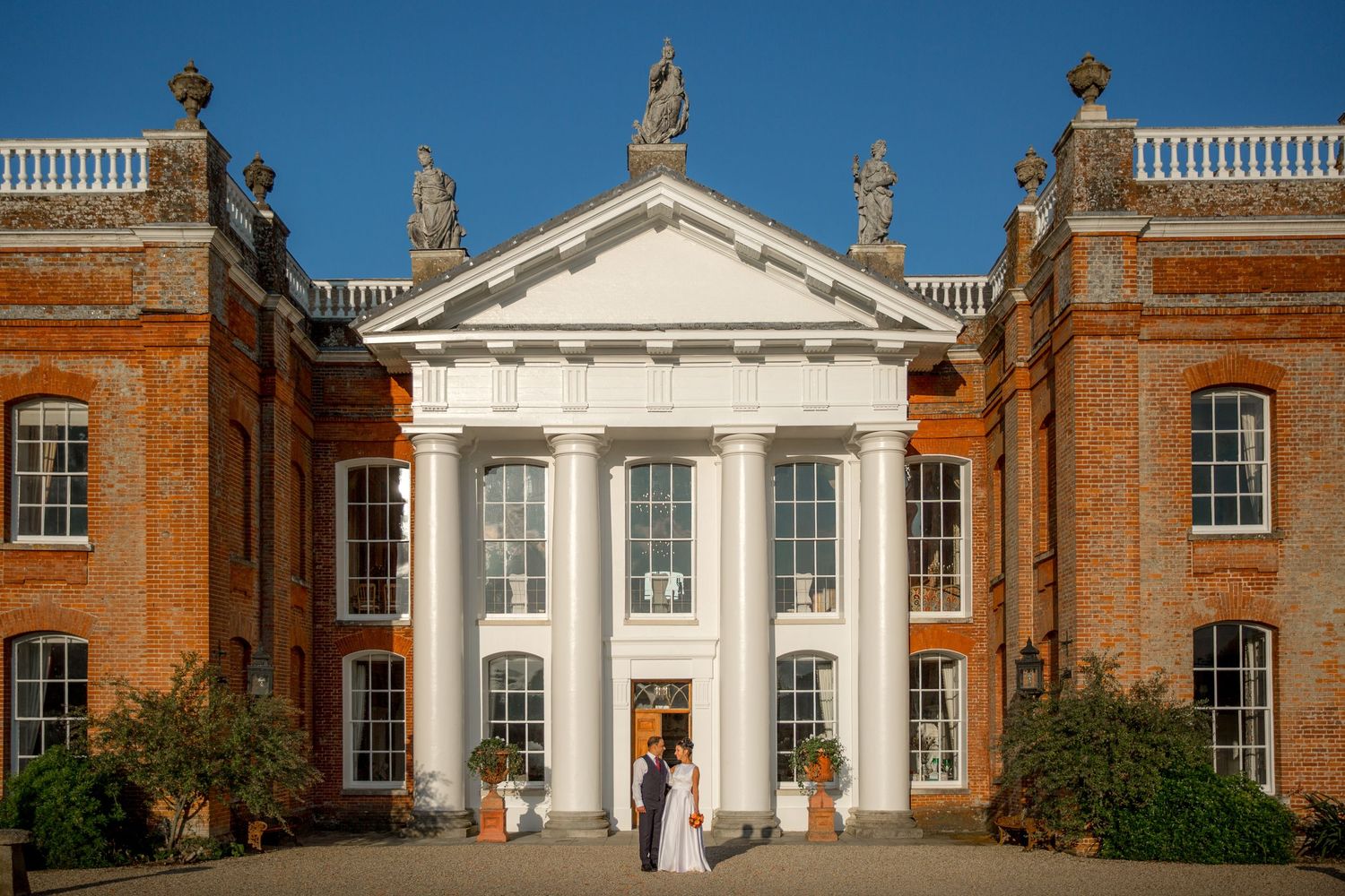 Classical architecture featuring ornate columns and balustrades at a historic mansion.