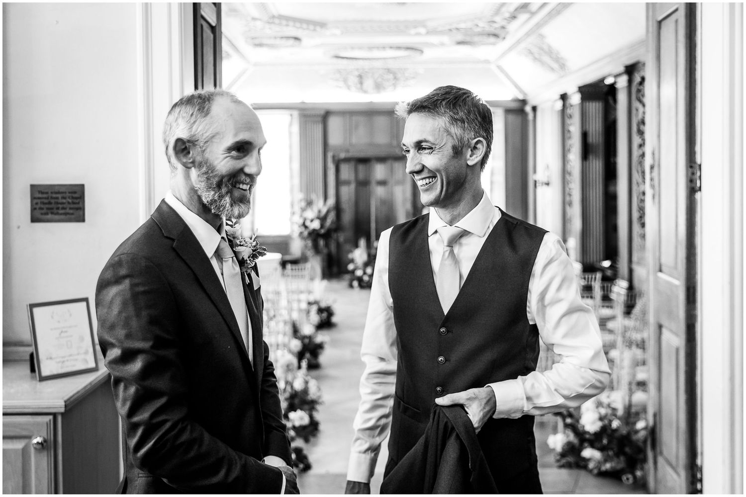 Groom and groomsman chatting outside the ceremony room at Walhampton School