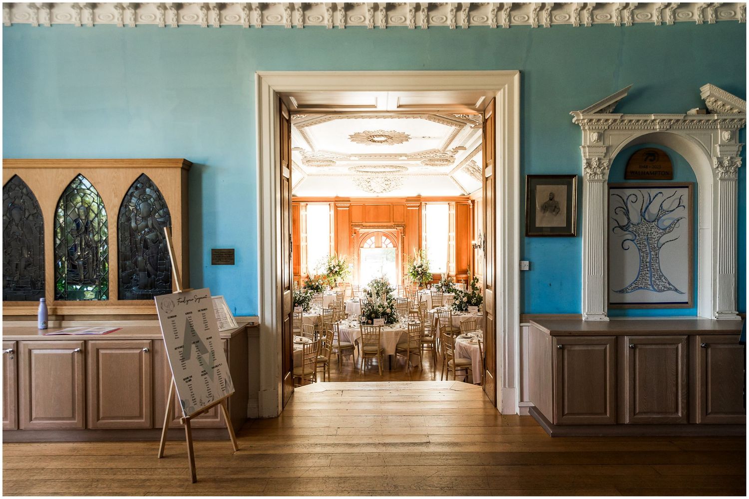 A view through the doorway into the main hall at Walhampton School, with the room set for a wedding breakfast