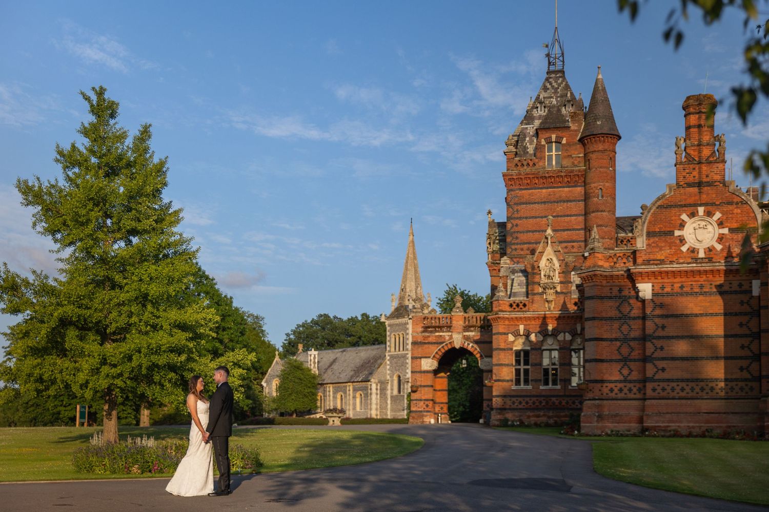 Wedding photography at The Elvetham Hotel in Hampshire with a bride and groom in front of the venue