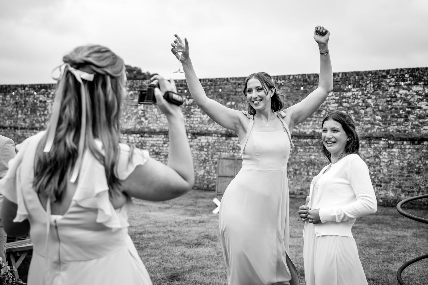 Wedding celebration with people dancing and celebrating outdoors.