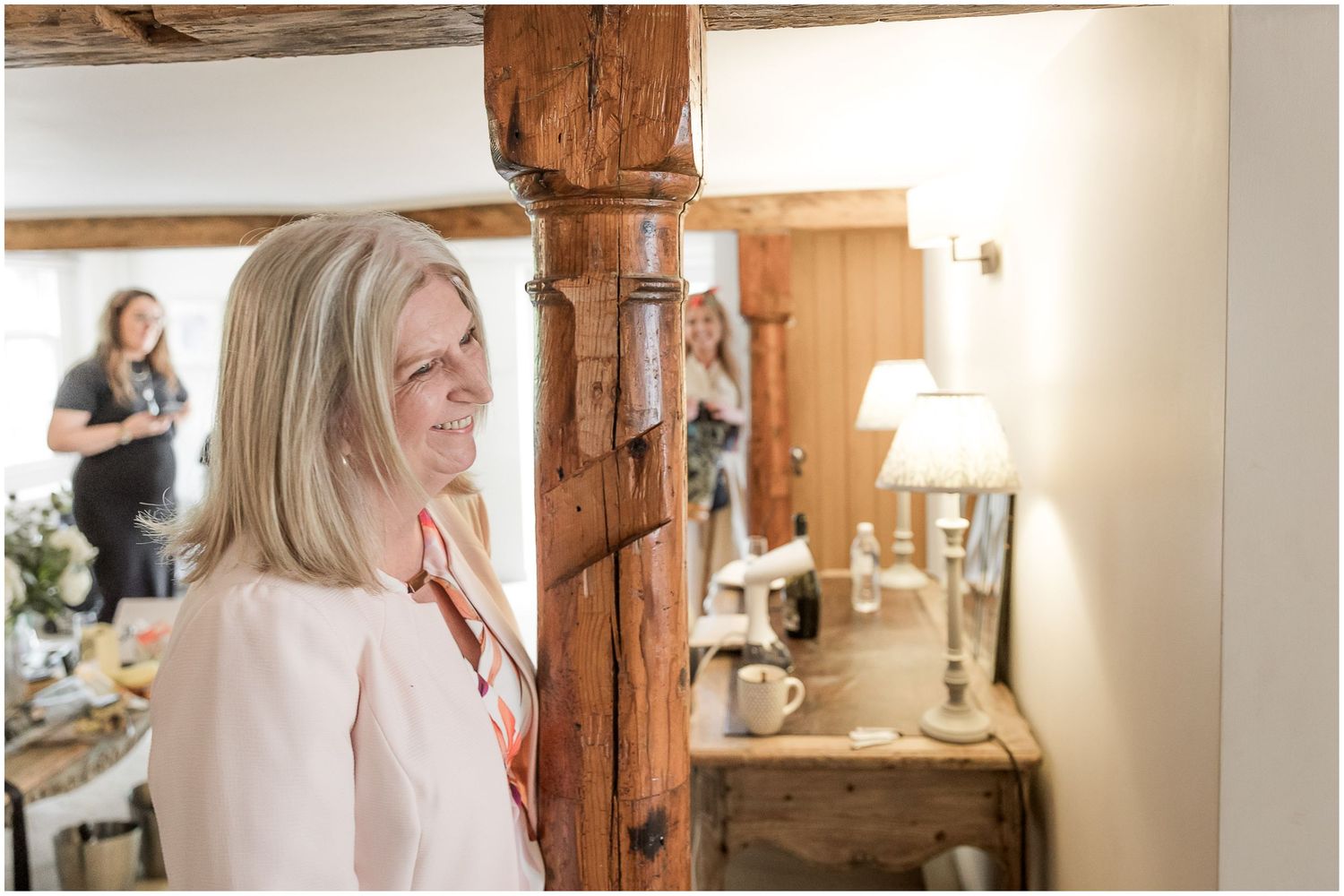 Rustic indoor venue with wooden beams and natural light for wedding preparations.