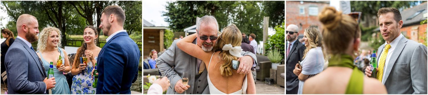 Wedding guests celebrate outdoors at a garden reception on a sunny summer day.