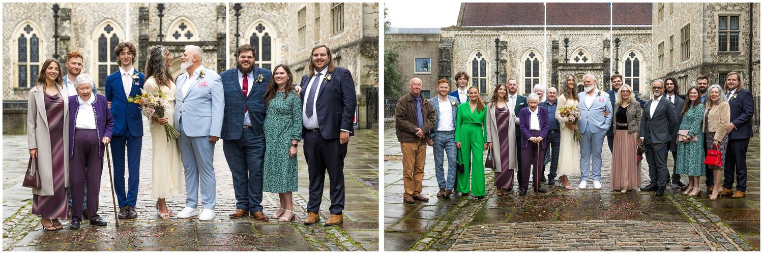 Wedding party members stand in line on stone steps outside Winchester registry office building during a formal celebration.