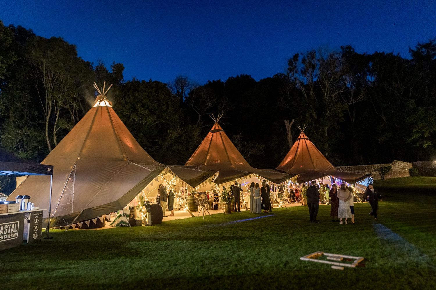 A wedding marquee illuminated at dusk at the Holywell Estate in Hampshire