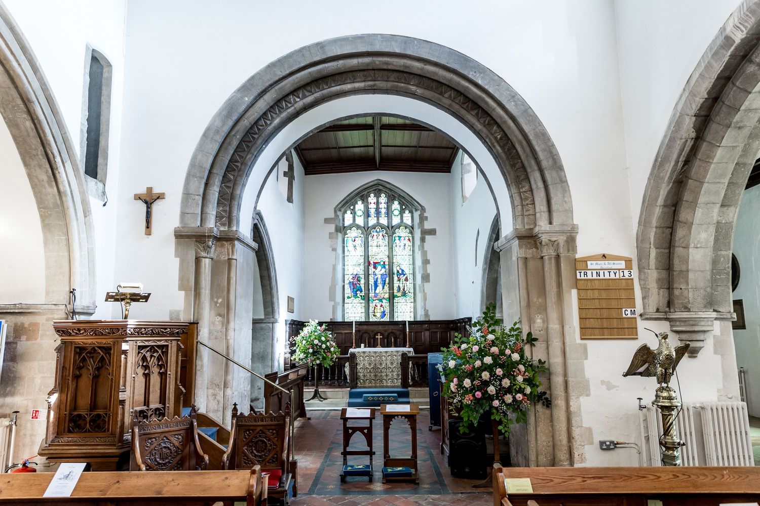 Interior panorama of a historic church with stone arches and traditional architecture.