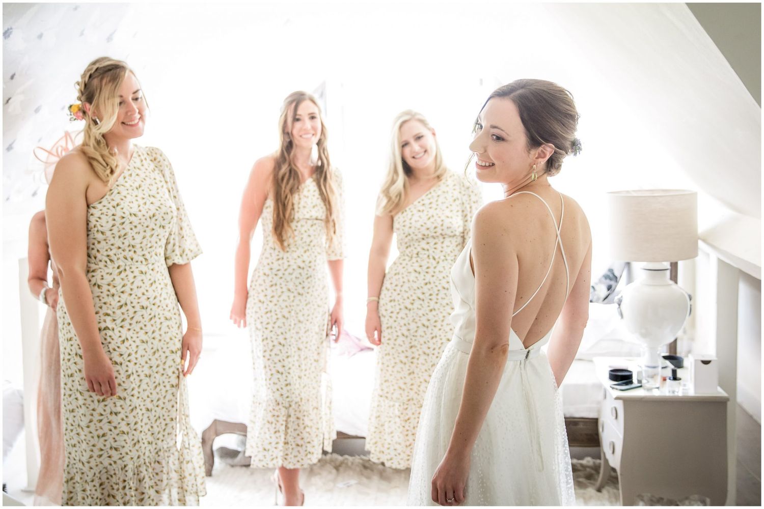 Bridesmaids wearing sparkly gold sequin dresses gather in sunlit room.