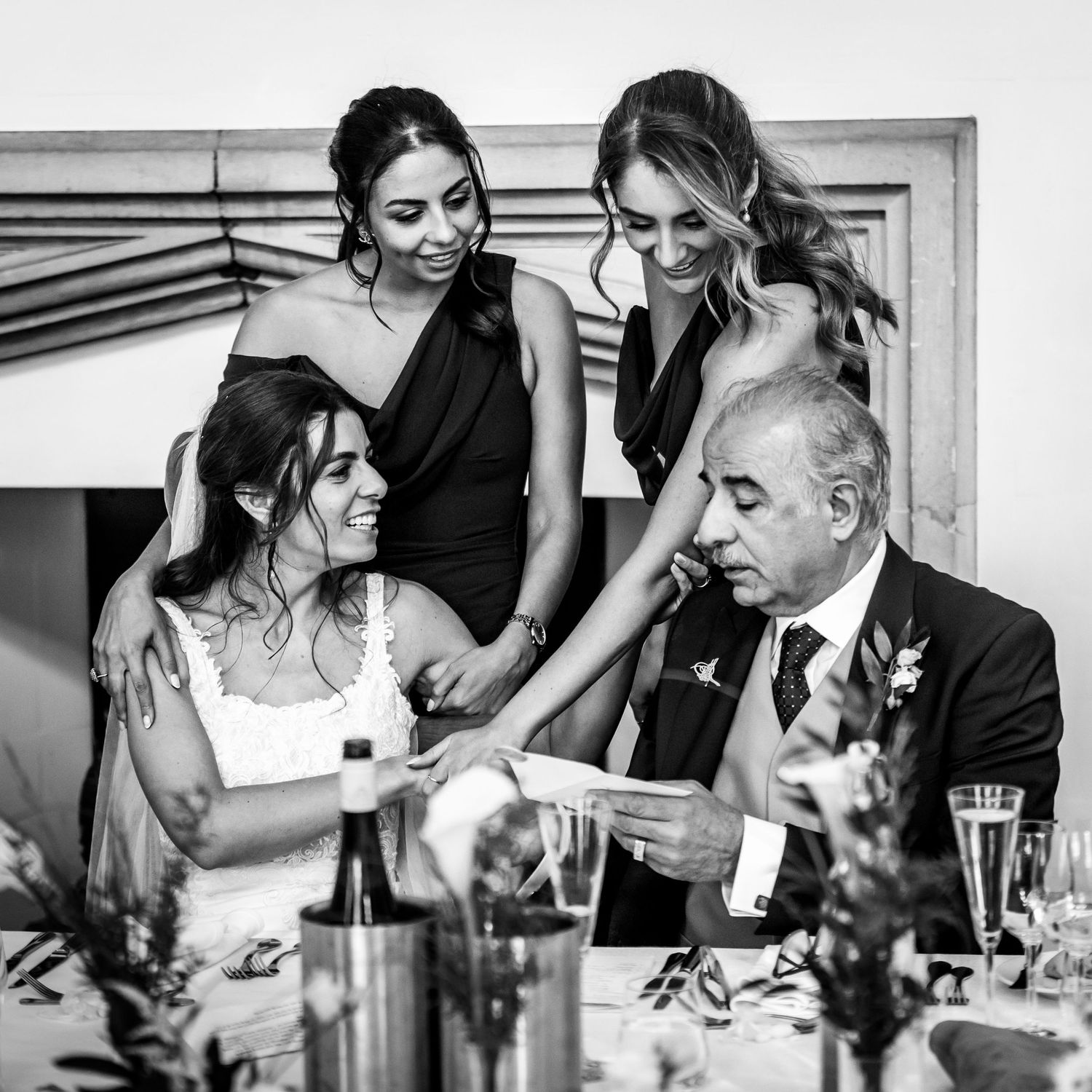Black and white photo series showing intimate moments during wedding reception speeches.