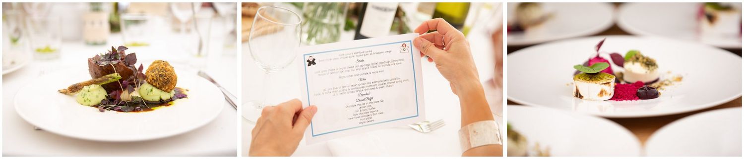 A fine dining restaurant table setting with multiple plated dishes and wine glasses in an elegant atmosphere.