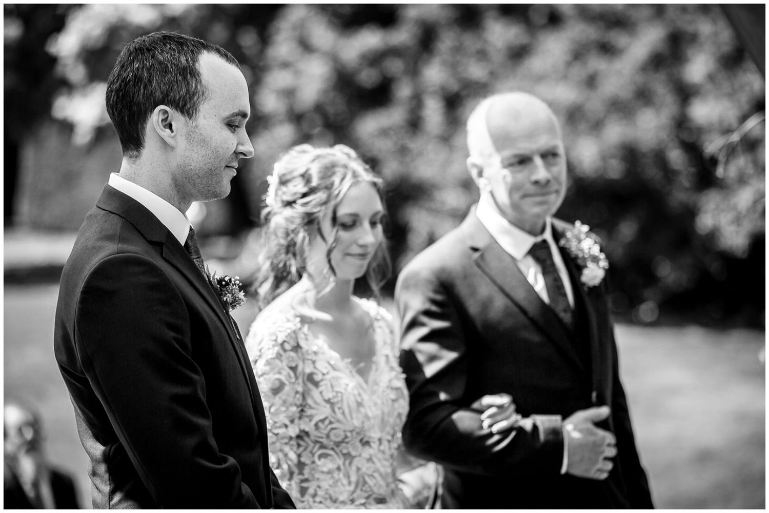 A series of black and white wedding photographs showing candid moments between couples during an outdoor celebration.