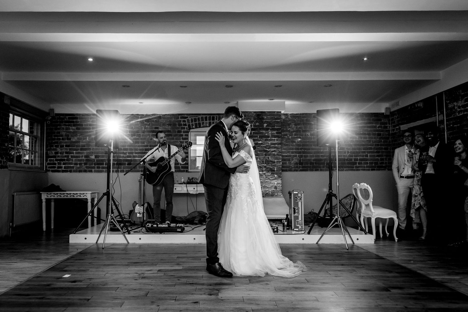 Dramatic black and white dance floor photos in a dimly lit reception venue.