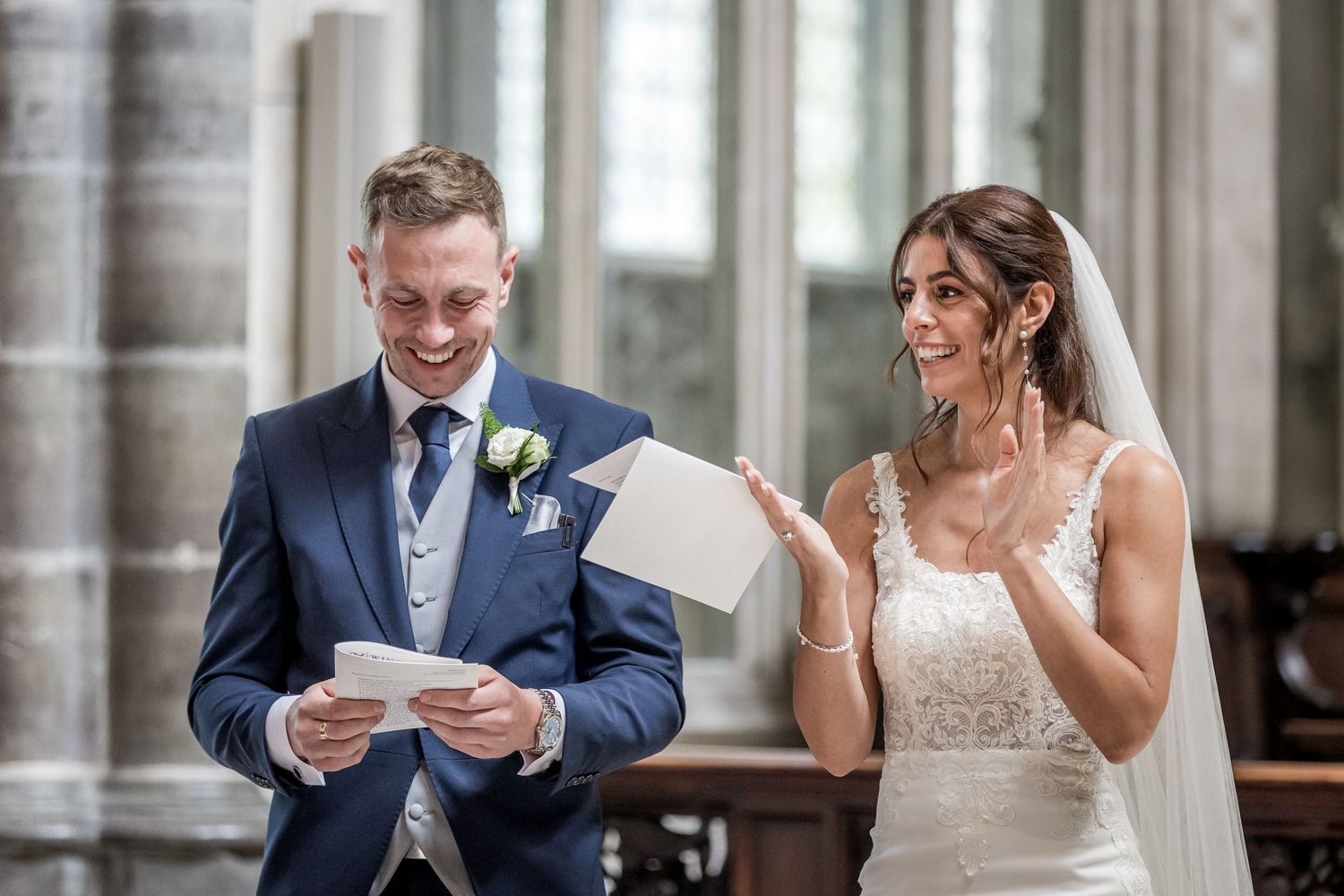 Emotional wedding ceremony moment captured in historic church setting.