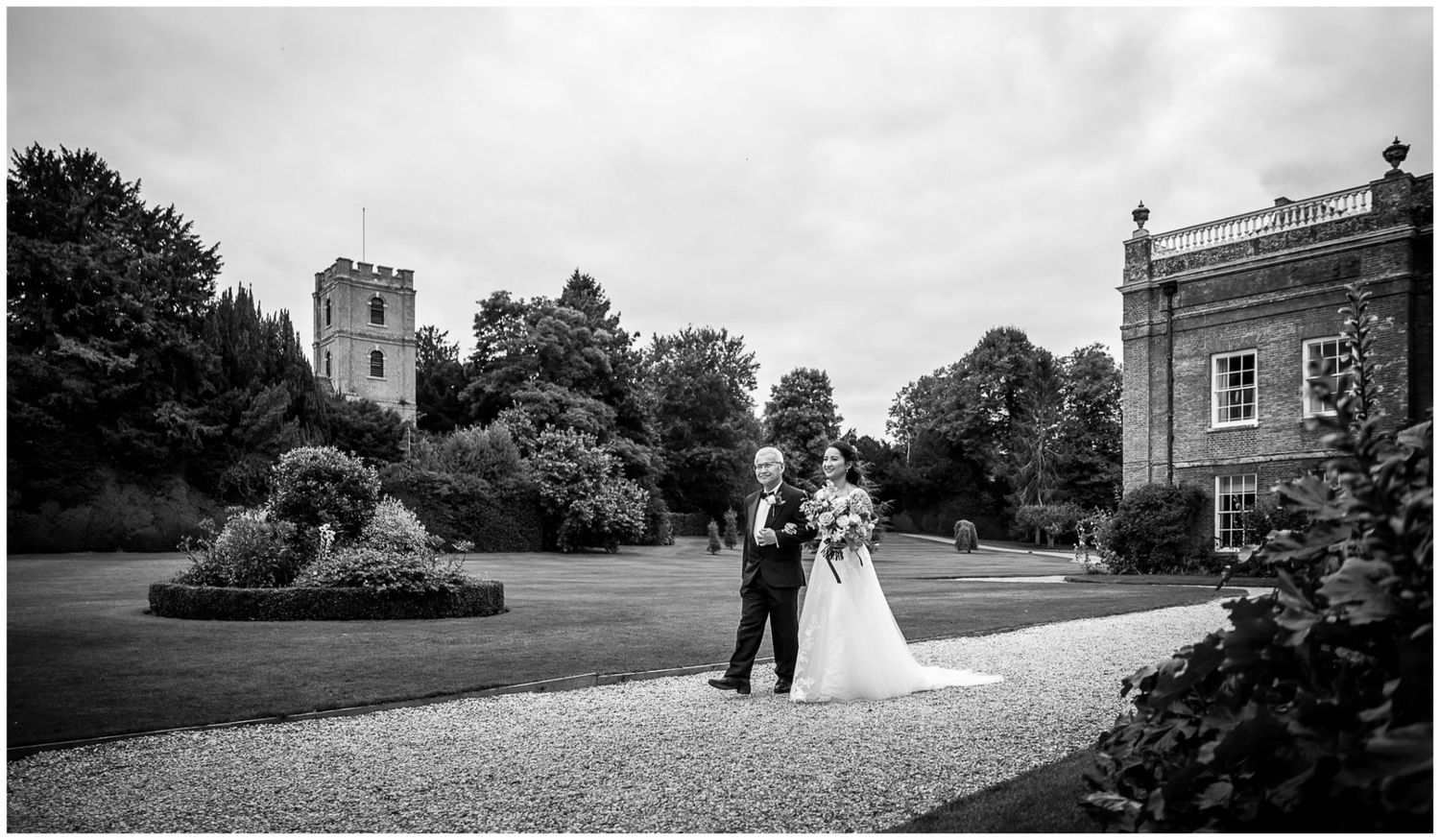 Wide landscape views of historic estate building and grounds during wedding celebration.