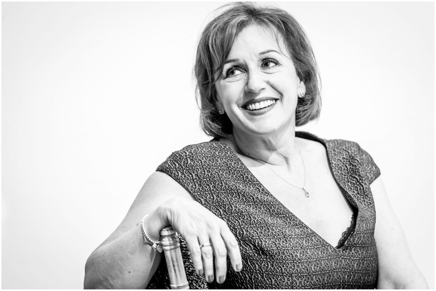 Black and white portrait series showing expressions of joy and laughter.