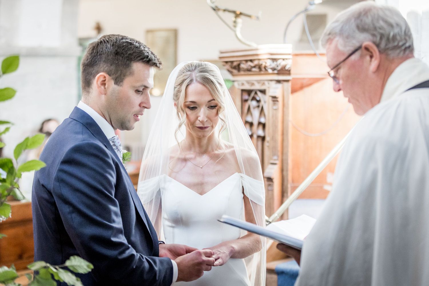 Wedding ceremony moments captured in bright church interior.