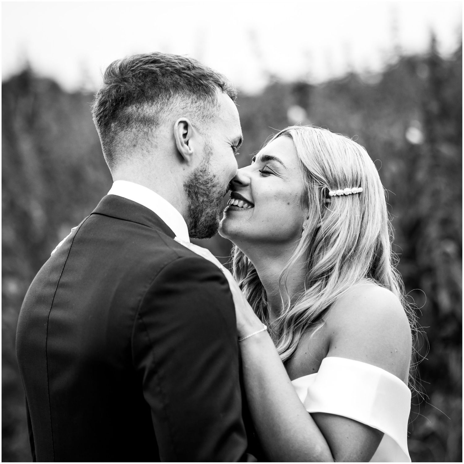 Black and white romantic wedding portraits in an outdoor garden setting.