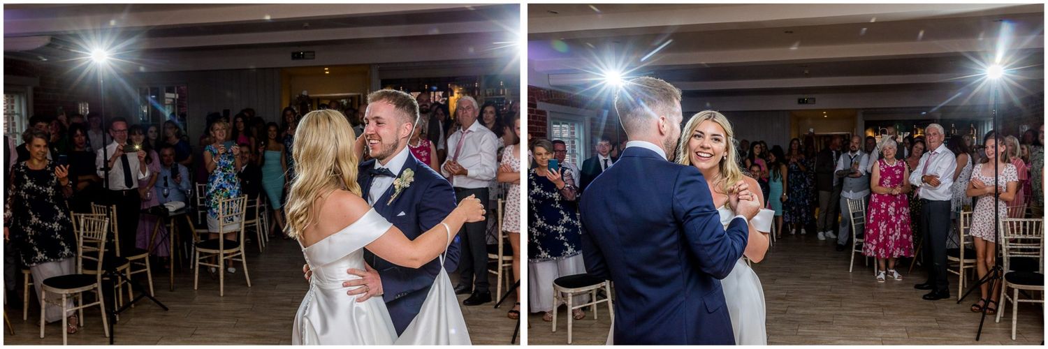 Wedding reception dance floor with guests celebrating under bright lights.