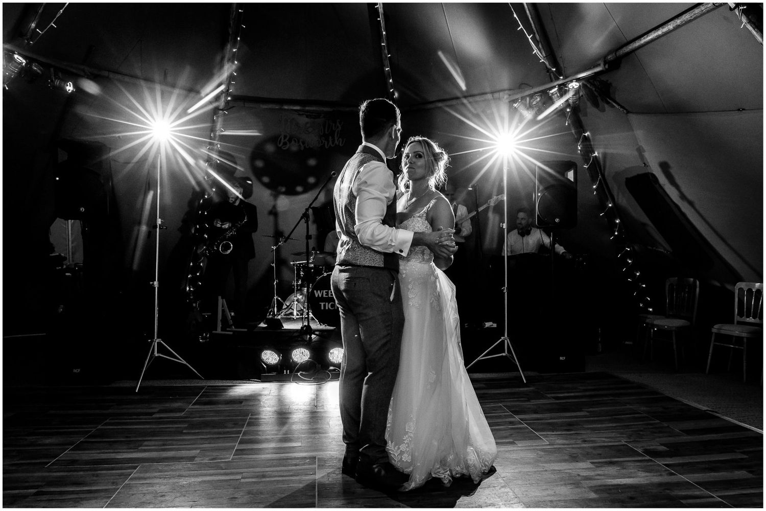 Black and white photos of first dance at wedding reception with dramatic lighting effects.